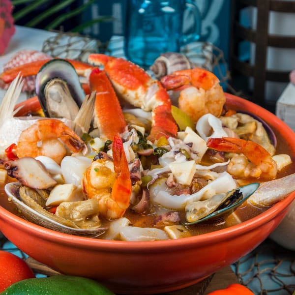 Close-up of a vibrant El Dorado Mexican seafood soup with shrimp, crab, mussels, and octopus.